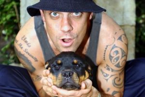 Famous UK singer Robbie Williams posing with his rottweiler